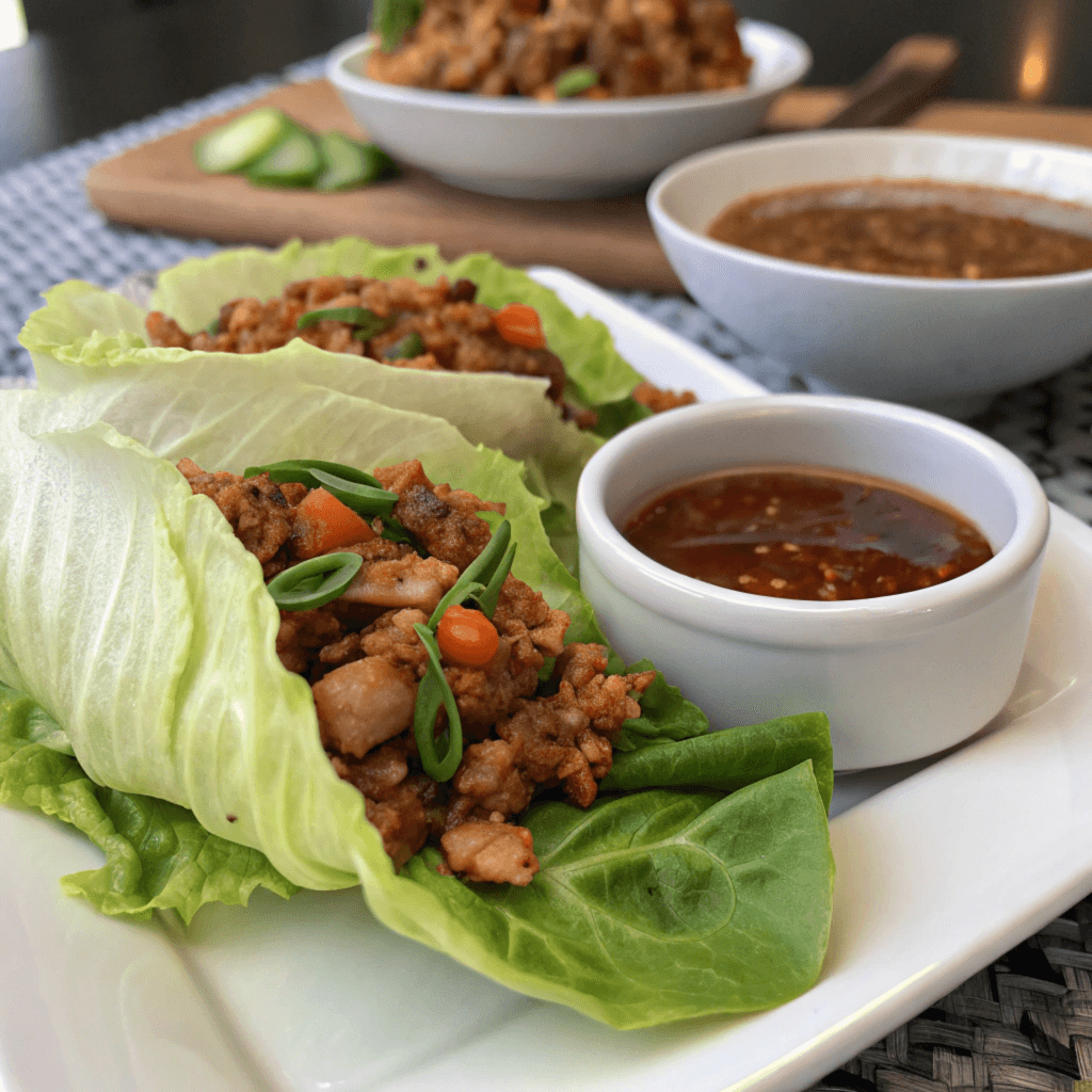 PF Chang’s lettuce wraps with seasoned protein, vegetables, and hoisin sauce in fresh lettuce leaves, offering a balance of savory and fresh flavors.