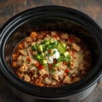 Crockpot chicken burrito bowl with shredded chicken, beans, and rice.