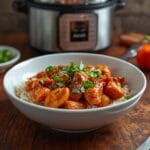 Sweet spicy chicken bowl with honey sriracha chicken, rice, broccoli, carrots, and sesame seeds
