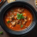 Cozy slow cooker vegetable soup simmering in a crockpot with potatoes and vegetables