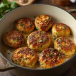 Crispy zucchini fritters stacked on a plate with dipping sauce