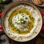 Creamy cucumber feta dip with fresh dill and olive oil served with pita bread.