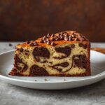 Chocolate vanilla marble cake slice showing rich chocolate and vanilla swirls.