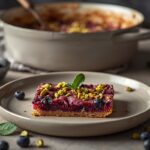 Blackberry pistachio dessert bars with buttery crumb topping and fresh blackberry filling.