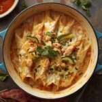 Creamy white chicken enchiladas topped with melted Monterey Jack cheese and green chilies