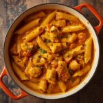 Creamy butternut squash pasta sauce served over pasta and garnished with fresh sage