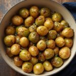 Close-up of crispy roasted Brussels sprouts and golden potatoes with caramelized edges.