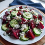 Close-up of Beet Salad with Feta Cucumbers and Dill showing ruby red beets creamy feta crumbles cucumber rounds and fresh dill in detail