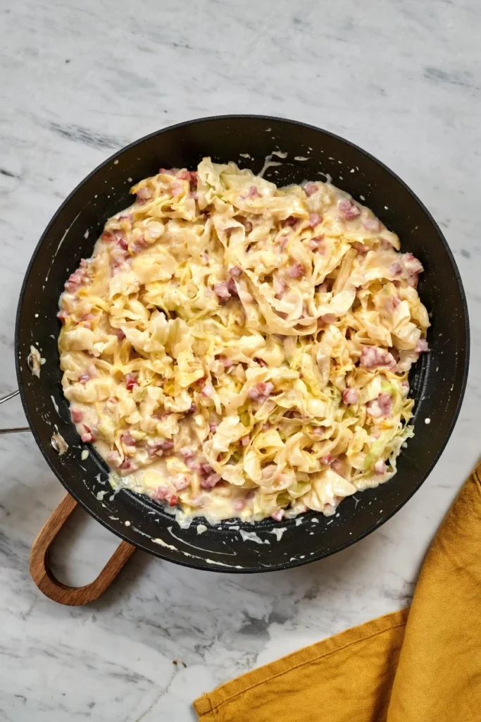 Close-up cabbage carbonara creamy Parmesan sauce bowl