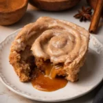 Close-up chai cinnamon roll pulled gooey caramel sauce
