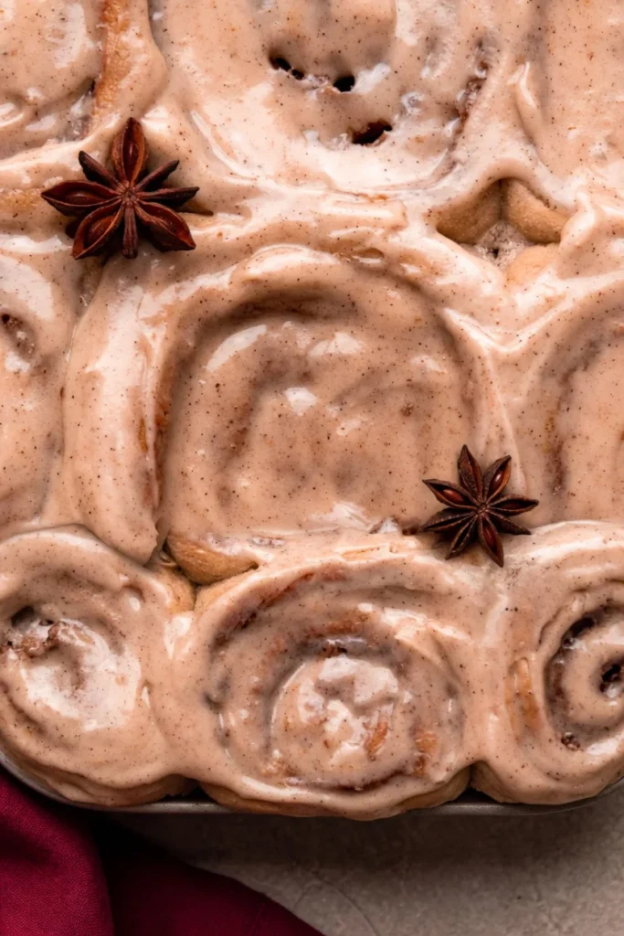 Chai cinnamon roll cut open showing spiced spiral filling