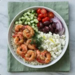 Close-up Greek shrimp bowl feta tzatziki cherry tomato