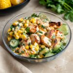 Street corn cucumber chicken salad with creamy smoked paprika dressing and feta in a white bowl