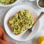Avocado toast smashed avocado olive oil closeup texture