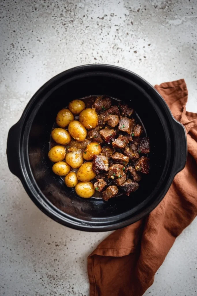 Beef bites potatoes garlic butter sauce closeup tender