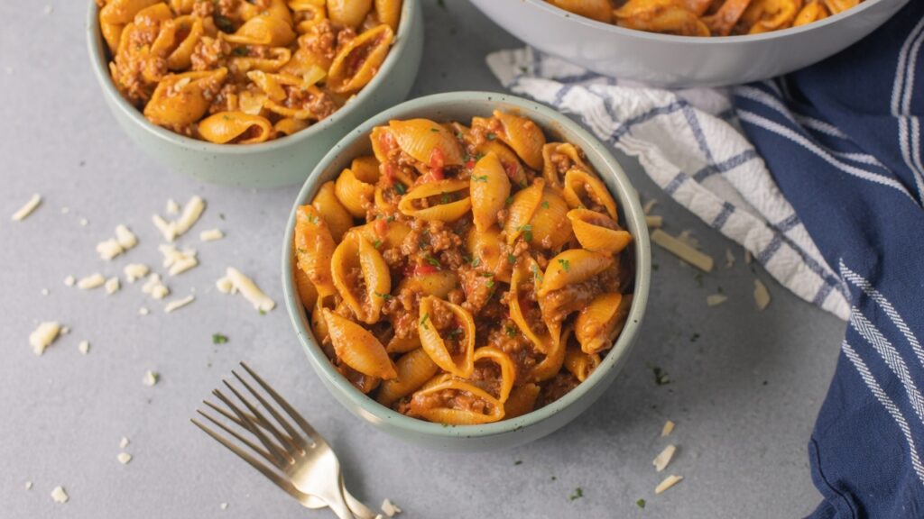 Taco pasta cheesy shell pasta ground beef closeup